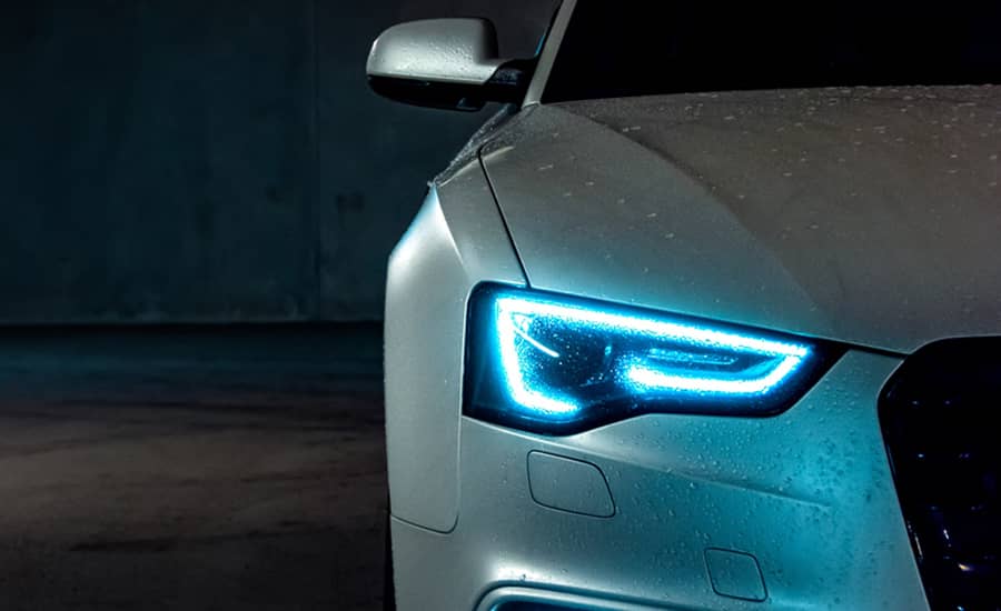 Wet Car with Headlights On